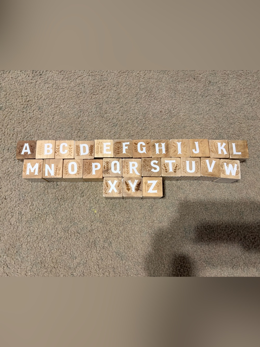 Crate & Barrel Wooden Alphabet Blocks featuring engraved letters and designs
